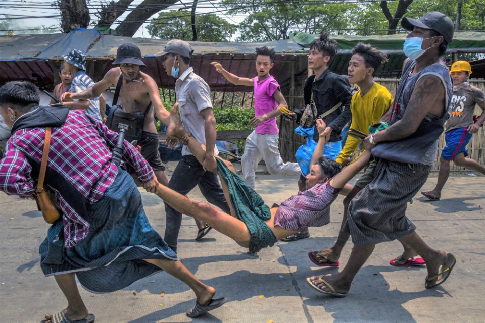 Protesters In Yangon, Myanmar, On Sunday, March 14, 2021, Assist A Man Injured During A Confrontation With Security Forces. (the New York Times)