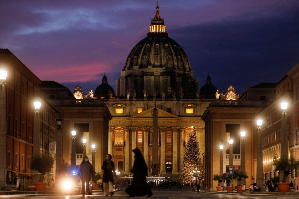 File Photo: The Sun Sets Behind The Dome Of St. Peter's Basilica Ahead Of The Christmas Eve Mass Celebrated By Pope Francis, In Rome