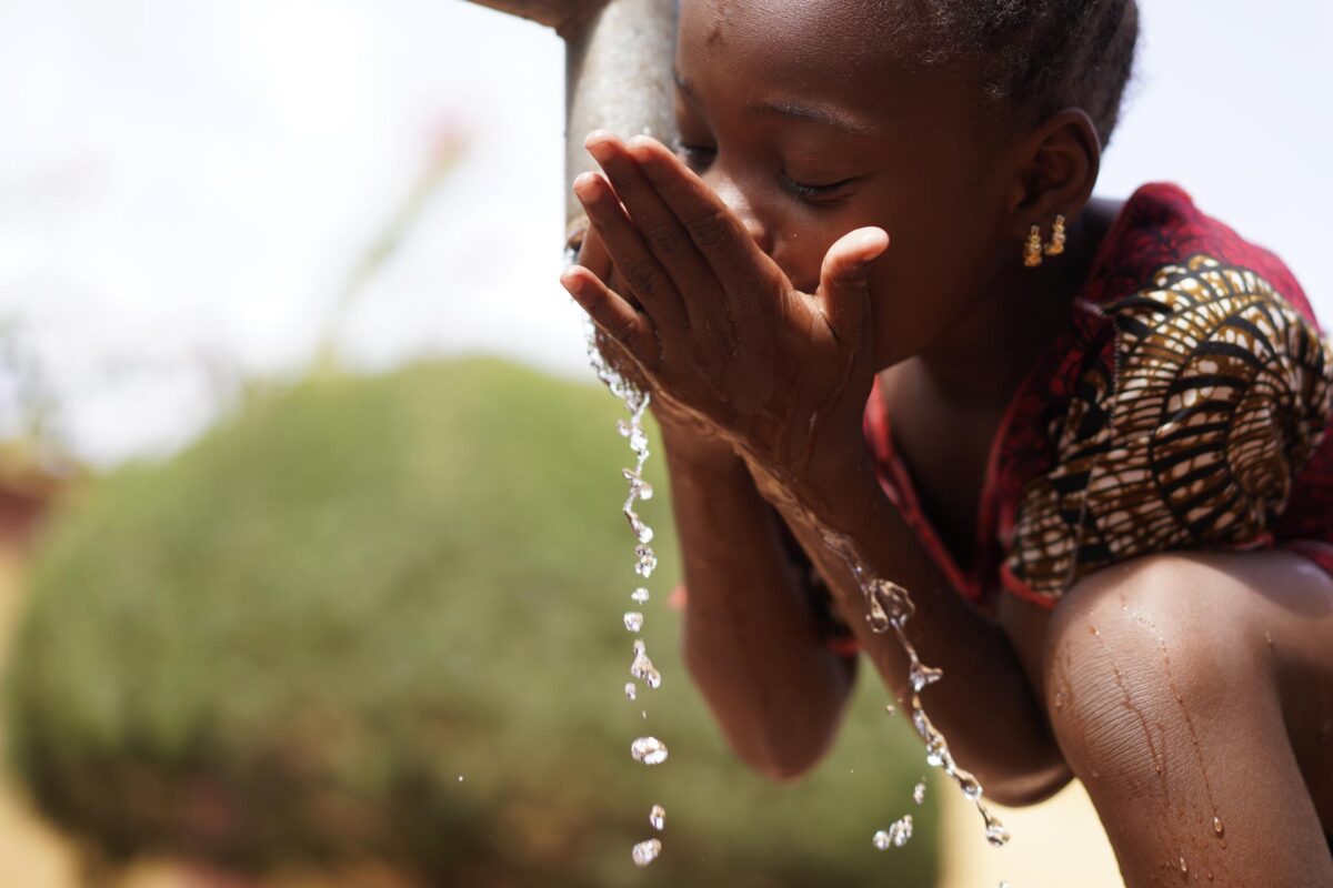 Tap young girl drinking water
