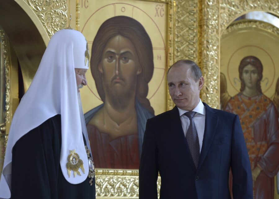 Russian President Putin listens to Patriarch of Moscow and All Russia Kirill at recently renovated St. Prince Vladimir Cathedral in Moscow