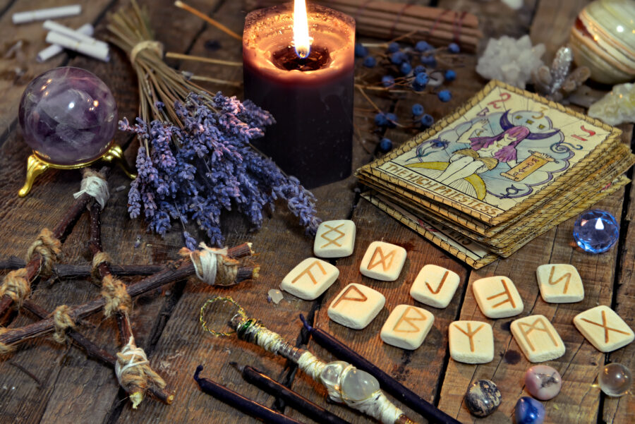 Tarot cards, ancient runes, black candle and pentagram. Occult,