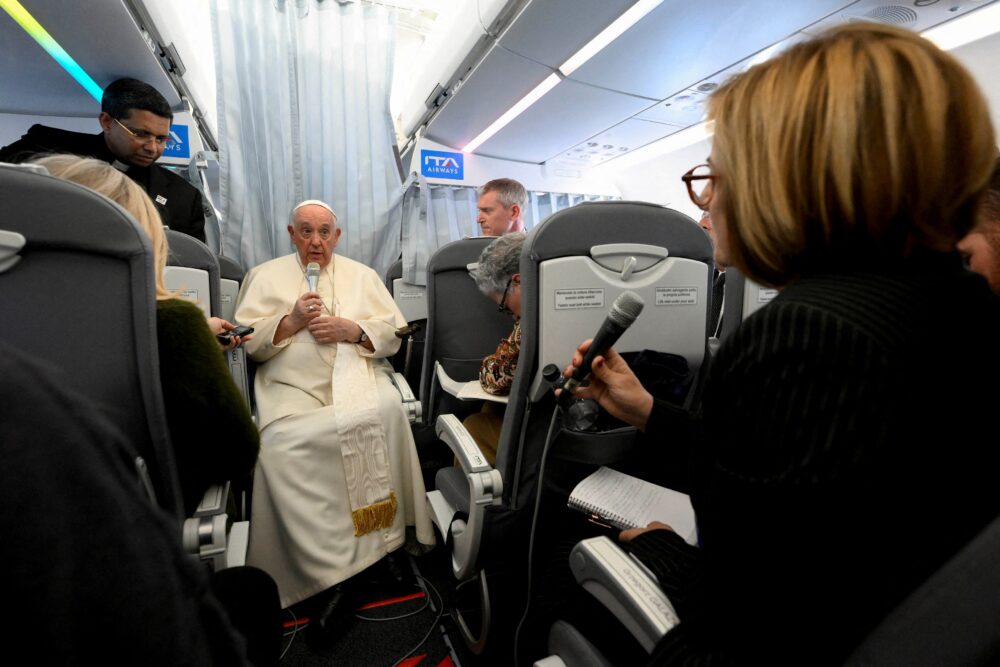 Pope Francis holds a news conference aboard the plane as he returns to the Vatican following his apostolic journey to Hungary