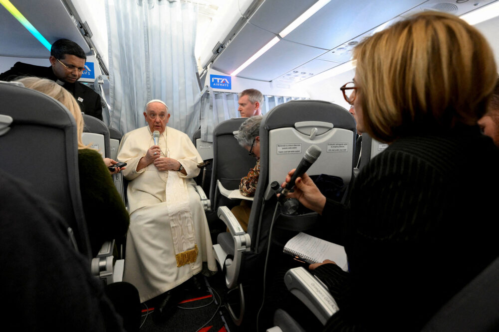 Pope Francis holds a news conference aboard the plane as he returns to the Vatican following his apostolic journey to Hungary