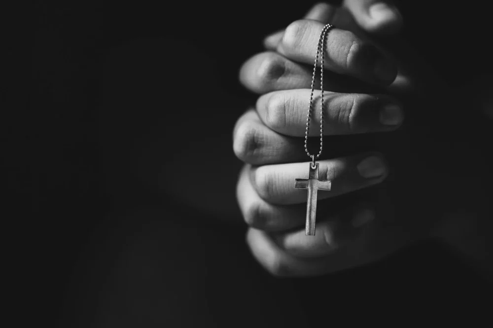 Hands holding cross while praying1